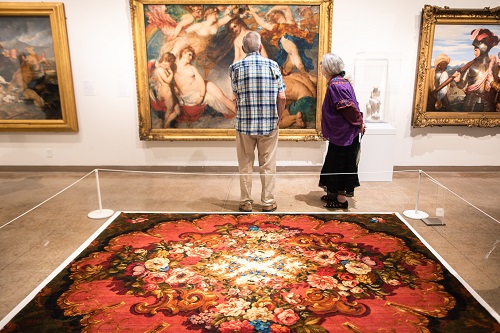 patrons viewing pre-raphaelite exhibit